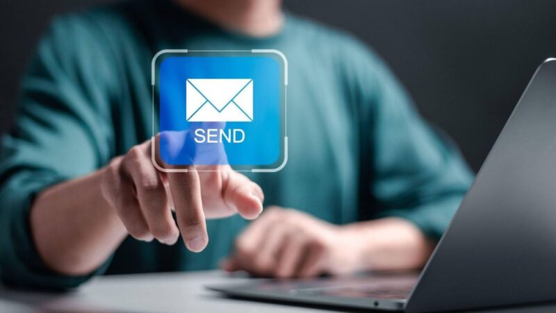 A marketer tapping on the email send button to visualize someone reading their email on Gmail.